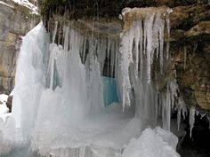 an icy waterfall with icicles hanging from it's sides