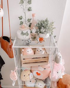 a white shelf filled with lots of stuffed animals and other stuff on top of it