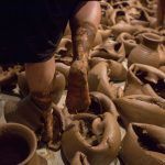 pottery being made in an art studio with hands working on the potter's wheel