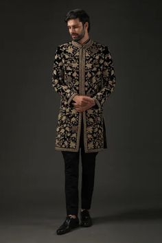 Black silk velvet sherwani with silk lining and zari, thread embroidery in floral motifs.
Component: 1
Pattern: Embroidered
Type Of Work: Zari
Neckline: Mandarin
Sleeve Type: Full
Fabric: Silk Velvet, Lining: Silk
Color: Black
Other Details: 
Zari work
Note: Pant worn by the model is not for sale
Occasion: Groom,Wedding - Aza Fashions Embroidery Sherwani For Men, Black Velvet Sherwani For Men, Black Sherwani Men, Sherwani Black, Sherwani Groom Wedding, Velvet Sherwani, Achkan For Men, Reception Suits, Jodhpuri Suits For Men