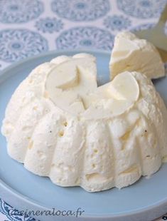 a blue plate topped with whipped cream next to a knife