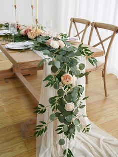 the table is set with flowers and greenery