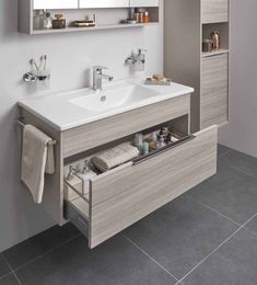 a bathroom with two sinks and a towel rack