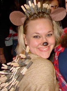 two people are posing for a photo with toothpicks on their heads and ears