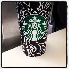 a starbucks cup sitting on top of a counter