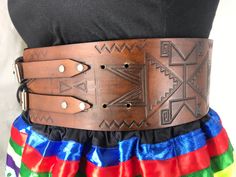 Our traditional hand-stamped leather belts are handcrafted with the utmost attention to detail and quality: Made from 9-10 oz vegetable-tanned leather (extremely thick) 4 inches wide Belts are adjustable up to 4 inches Intricate floral and geometric pattern stamping designs created by our Indigenous design team Hand dyed in-house in a range of natural finishes Require regular oiling to maintain durability and longevity (recommended oiling once a year) Custom-made: each belt will be slightly diff Traditional Brown Belt Buckles, Traditional Brown Leather Belt Buckles, Traditional Hand Tooled Brown Belt, Traditional Brown Belt Buckles With Matching Belt, Traditional Adjustable Brown Belt Buckles, Adjustable Brown Traditional Belt Buckles, Brown Hand Tooled Bohemian Belts, Traditional Leather Belt Buckle, Adjustable, Adjustable Leather Belt Buckles In Traditional Style