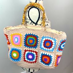 Vintage Style Granny Square Crochet Zippered Hand Bag Tote With Bamboo Handles Designed For Days At The Beach, Keep Your Sunglasses, Spf And Current Book All In One Place. The Intricate Crochet Combines A Cream Backdrop With Granny Squares Woven On The Sides Adding A Little Something To Your Outfit. Vibrant Granny Squares On A Cream Crochet Background Make This The Ultimate Boho Summer Bag! Bamboo Handles Metal Zipper Closure Fully Lined Hand Made 90% Cotton 10% Polyester 14.5” X 10” X 5” 6” Handle Drop 49/Mbc Beige Granny Square Shoulder Bag, Chic Multicolor Crochet Bag With Braided Handles, Retro Crochet Bag For Beach, Chic Multicolor Crochet Tote Bag, Retro Square Crochet Bag, Chic Multicolor Rectangular Crochet Bag, Trendy Red Crochet Bag, Multicolor Crochet Bag, Crochet Background