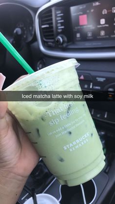 a person holding a green drink in their hand with the words iced matcha latte with soy milk