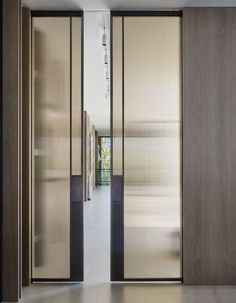 an open door leading into a hallway with sliding glass doors