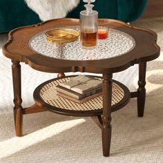 a coffee table with a glass top and some books sitting on it's side