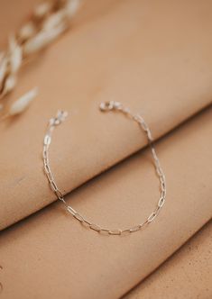 A delicate link chain that catches the light perfectly. Bracelet is adjustable from 6.5 - 7". Available in 14kt Gold Fill + Sterling Silver. Claire stacks it with our Pearl Bracelet. Cat pairs it with our Wander Cuff. Handmade in Eau Claire, WI. Our jewelry is handmade so each piece will be unique and may vary slightly from what is pictured. Everyday Sterling Silver Gold Bracelet With Adjustable Chain, Adjustable Dainty Sterling Silver Paperclip Bracelet, Delicate Sterling Silver Bracelet With Adjustable Chain, Silver Adjustable Paperclip Bracelet With Delicate Chain, Silver Paperclip Bracelet With Delicate Adjustable Chain, Adjustable Silver Paperclip Bracelet With Delicate Chain, Dainty Sterling Silver Link Paperclip Bracelet, Minimalist Silver Paperclip Bracelet With Delicate Chain, Dainty Sterling Silver Link Bracelet