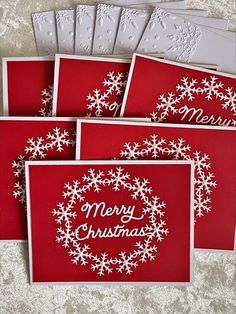 four cards with snowflakes on them and merry christmas written in the middle one