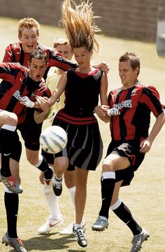 a group of young people playing a game of soccer