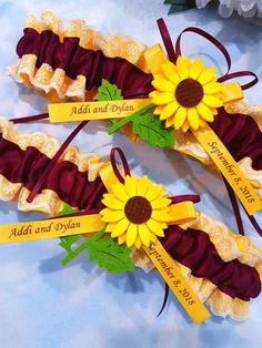 two sunflower garters with name tags on them sitting next to each other