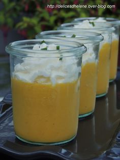 three jars filled with food sitting on top of a table next to eachother