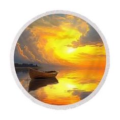 a round beach towel with a boat on the water in front of an orange and yellow sunset