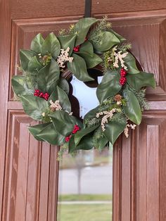 a wreath is hanging on the front door