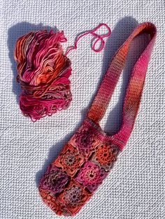 a crocheted bag and a ball of yarn