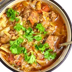 a bowl filled with meat and vegetables on top of a table