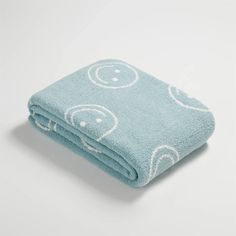 a blue towel with smiley faces on it