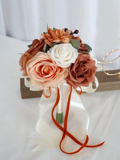 a bridal bouquet with orange and white flowers