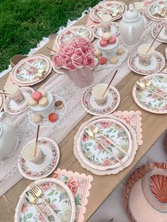 the table is set with pink and white plates