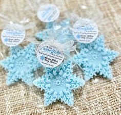 blue snowflakes are wrapped in clear cellophane and tied with ribbon