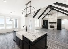 a large kitchen with an island in the middle and two sinks on each side of the room