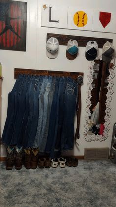 there are many pairs of jeans hanging on the wall