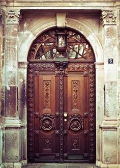 an old building with two large wooden doors