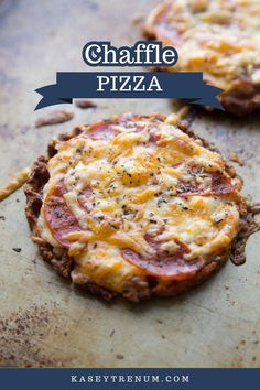 two small pizzas sitting on top of a pan covered in cheese and toppings