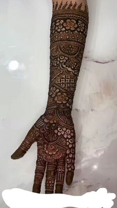 a woman's hand with henna on it