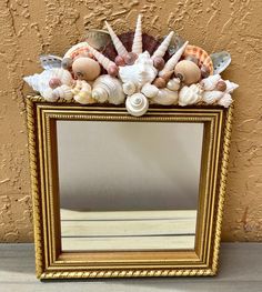 a mirror with shells and seashells on it