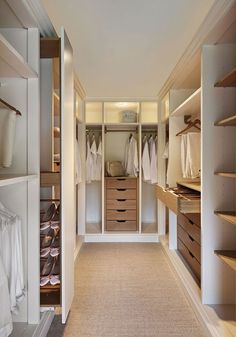 an empty walk in closet with lots of drawers