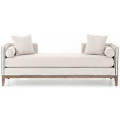 a white couch with two pillows on it