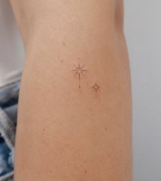 a small tattoo on the back of a woman's stomach