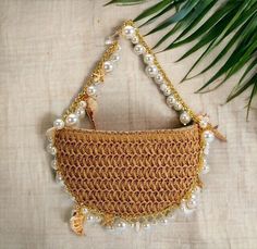 Boho Beach Handbag - Seashell Pearl Handbag - Summer Purse    This stunning boho beach handbag is the perfect summer accessory. Hand crocheted from high quality materials, this purse is both stylish and durable. The natural colored crochet creates a beautiful backdrop for the delicate seashells and pearls that adorn the bag. The gold chain adds a touch of elegance, making this purse perfect for a day at the beach or a night out on the town. Beige Shoulder Bag With Pearl Handle For Vacation, Bohemian Handheld Shoulder Bag For Beach Season, Summer Shoulder Bag With Pearl Handle For Everyday Use, Summer Beige Shoulder Bag With Pearl Handle, Summer Beach Bags Made Of Shell, Summer Beach Pouch Shoulder Bag, White Pouch Straw Bag For Beach, Beige Straw Pouch Bag For Beach, Beige Pouch Straw Bag For Beach