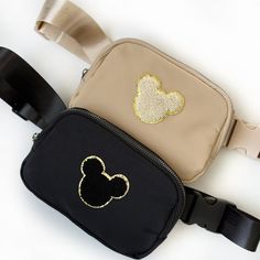 This will be your new favorite fanny pack! Great for everyday use or for your next visit to your favorite themed park. Not to mention they will make the perfect gift!Details: All fanny packs come with sewed-on chenille patches. Materials: nylon Black and beige styles are approximate sizes: 8 X 5 X 2(LxHxW)Pink mouse, blue smiley, yellow and orange smiley are approximately size 11''x5 1/2''x1'' (LxHxW)Approximate strap size: 42” inches Disney Belt Bag, Disney Trip Outfits, Disney Bachelorette, Chenille Patches, Disney World Outfits, Disney Patches, Loungefly Bag, Disney Bag, Disneyland Trip