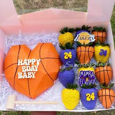 a birthday cake in the shape of a heart with basketballs and pineapples