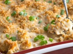 a red casserole dish filled with chicken and gravy