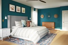 a bedroom with blue walls and white furniture