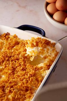 a casserole dish filled with mashed potatoes and topped with crumbs