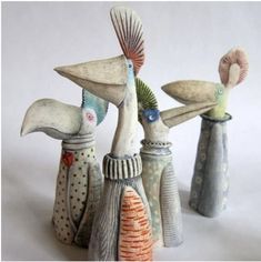 three ceramic birds sitting on top of each other