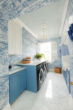 a laundry room with blue and white wallpaper