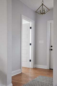 an empty room with white walls and wood flooring is pictured in this image from the doorway