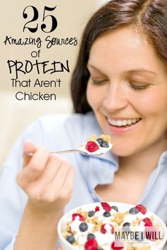 a woman eating cereal with berries and yogurt