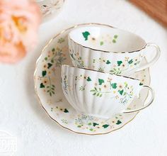 three cups and saucers sitting on a table