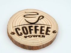 a wooden coaster with the words coffee power on it and a cup in the center