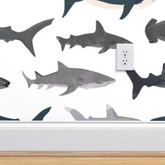 a wall mounted light switch with sharks on it