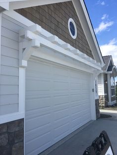 a white garage door on the side of a house